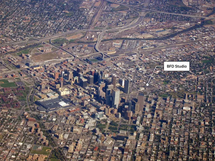 Aerial photograph of downtown Denver, with a label marking the Black Flag Design studio just outside the central business district.